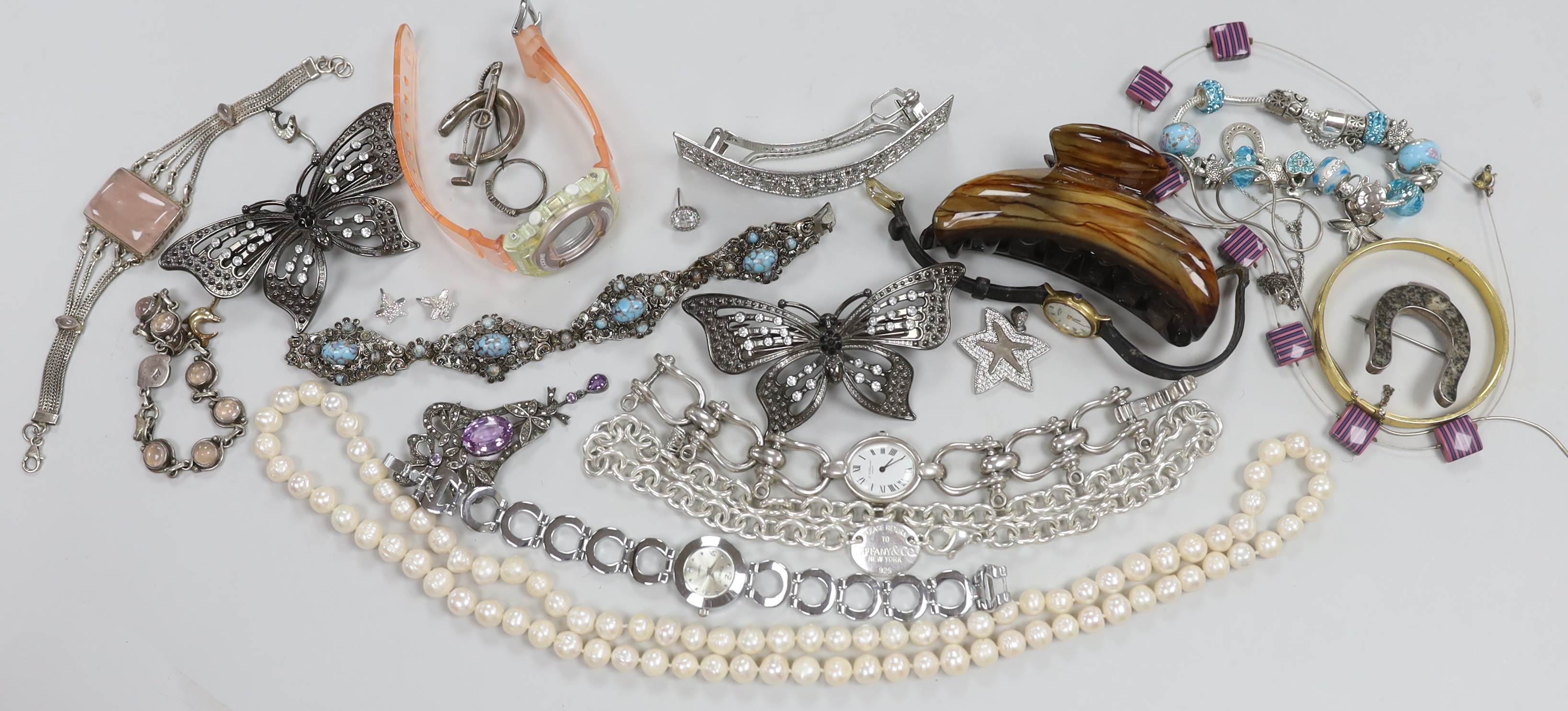 Four assorted 9ct gold and gem set rings, gross weight 6.3 grams, a 925 and rose quartz bracelet, a silver bracelet watch, a silver horseshoe and riding crop brooch and other jewellery including costume.